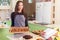 Portrait of female chef baking cookies and cakes standing smiling at camera showing fresh-baked pastry