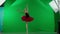 Portrait of female on chroma key green screen background. Full body shot ballerina in red tutu and dark body dancing