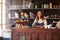 Portrait Of Female Coffee Shop Owner Standing Behind Counter