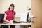 Portrait Of Female Consultant Working At Desk In Office