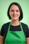 Portrait of female cook with green apron and black t-shirt