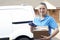 Portrait Of Female Courier With Van Delivering Package To House