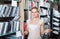 Portrait of female customer choosing bedding set in shop