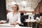 Portrait Of Female Customer Services Agent Working At Desk In Call Center