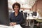 Portrait Of Female Customer Services Agent Working At Desk In Call Center