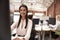 Portrait Of Female Customer Services Agent Working At Desk In Call Center