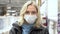 Portrait of a female customer in a store in a medical mask. A woman in a supermarket wearing a protective mask. The