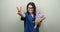 Portrait of female doctor showing ok hand sign, happy smiling medic with bouquet of flowers