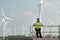 Portrait of female engineer at Natural Energy Wind Turbine site with the mission of being responsible for taking care of large