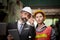 Portrait of female Engineer standing with businessman in production line.