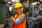 Portrait of female Engineer standing with confident against machine environment in factory, Engineers operating a machine in