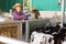 Portrait of female farm worker feeding calves