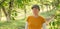 Portrait of female farm worker wearing orange t-shirt and trucker`s hat in walnut tree orchard