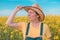 Portrait of female farmer agronomist in blooming rapeseed crops field