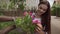 Portrait of female florist cutting dry leaves from flowers