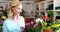 Portrait of female florist standing with arms crossed in flower shop