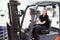 Portrait Of Female Fork Lift Truck Driver In Factory