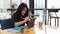 Portrait of female freelancer focusing with digital tablet on worktable