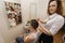 Portrait of female hairstylist cutting male customer\'s hair in shop