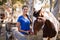 Portrait of female jockey cleaning horse