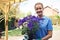 Portrait Of Female Landscape Gardener Holding Plant