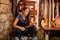 Portrait of a female leather artisan in her workshop with hand-made belt