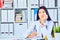 Portrait of female medicine therapeutist doctor sitting at her office and waiting for patient to examine. Medical help