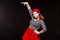 Portrait of female mime artist performing, isolated on black background. Woman raised her hand up. A symbol of growth
