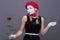 Portrait of female mime with red hat and white