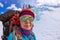 Portrait female mountaineer with backpack, helmet and harness with climbing in mountain