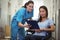 Portrait of female nurse assisting patient over clipboard