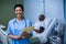 Portrait of female nurse standing with file in ward