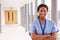 Portrait Of Female Nurse Standing In Hospital Corridor