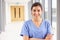 Portrait Of Female Nurse Standing In Hospital Corridor