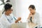 Portrait of female Obstetrician-gynecologist consulting woman in doctors officce