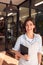 Portrait Of Female Owner Of Florists With Digital Tablet Standing In Doorway Surrounded By Plants