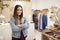 Portrait Of Female Owner Of Independent Clothing And Gift Store Standing By Sales Desk