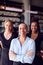 Portrait Of Female Owner Of Restaurant Bar With Team Of Waiting Staff Standing By Counter