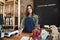 Portrait Of Female Owner Of Sustainable Plastic Free Grocery Store Behind Sales Desk