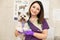 Portrait female professional veterinarian with her patient dog breed yorkshire terrier in pet hospital