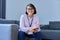 Portrait of female psychologist sitting on sofa in office