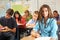 Portrait Of Female Pupil Studying At Desk In Classroom