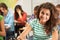 Portrait Of Female Pupil Studying At Desk In Classroom