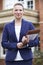 Portrait Of Female Realtor Standing Outside Residential Property