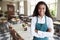 Portrait Of Female Restaurant Manager In Empty Dining Room