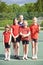 Portrait Of Female School Tennis Team With Coach