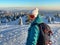 PORTRAIT: Female snowboarder wearing orange goggles smiles before descent.