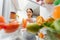 Portrait of female standing near open fridge full of healthy food, vegetables and fruits