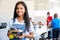 Portrait Of Female Student Building Robot Vehicle In After School Computer Coding Class