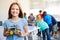 Portrait Of Female Student Building Robot Vehicle In After School Computer Coding Class